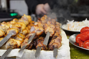 Street food. Chicken and pork meat roasted on skewers are on food stall. Christmas fair in Ukraine