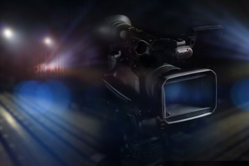 professional video camcorder in studio with on-air light backgro