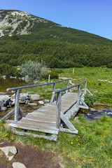 Fototapeta na wymiar wooden bridge near Bezbog lake in Pirin Mountain, Bulgaria