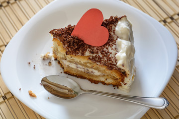 Piece of Valentine's Day cake closeup with clear spoon