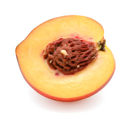 Half of peach with stone on white background