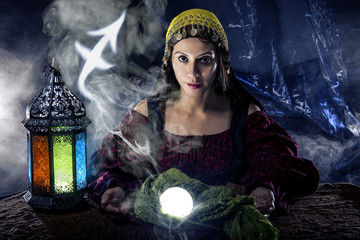 Psychic or fortune teller with crystal ball and horoscope zodiac sign of Sagitarius