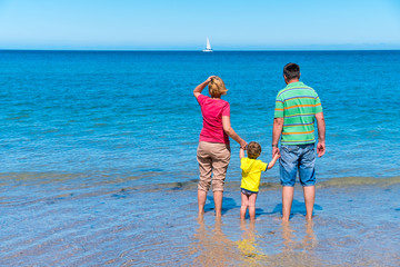 Grandfather and grandmother with grandson holding hands