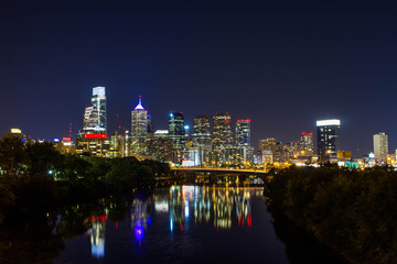 A long exposure of the Philadelphia skyline, with light reflecting on the river