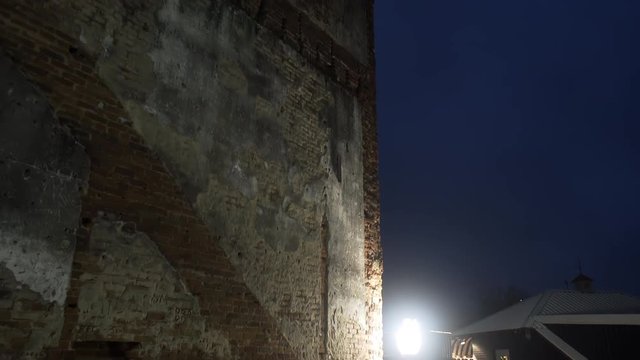 Establishing shot tilt up in a night scene of an old brick wall 4k