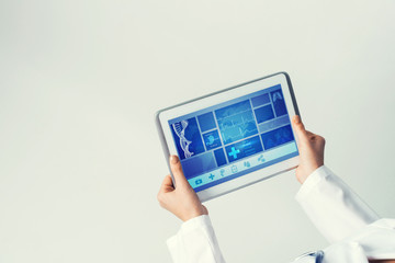 Close of female doctor hands working with tablet pc computer