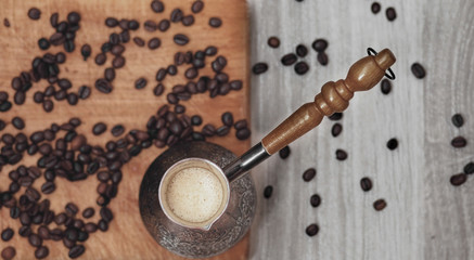 Coffee beans and coffee pot on the wooden board

