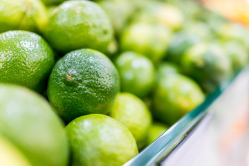 Macro closeup of many limes on display for sale