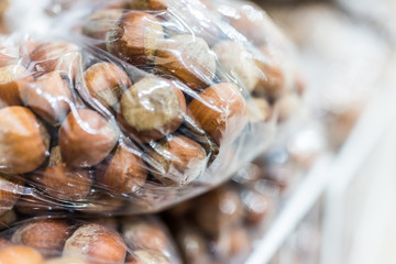 Raw unshelled hazelnuts in plastic bags for sale
