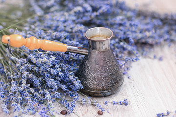 Lavender and coffee pot on the wooden floor. Beautiful floral picture
