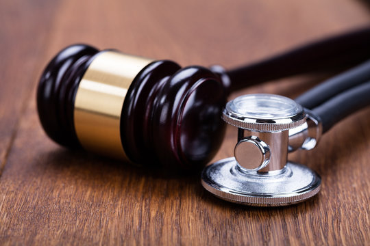 Close-up Of Gavel With Medical Stethoscope
