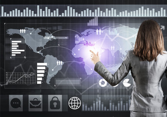 Businesswoman standing with back and pressing icon on media screen