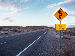 double curved ahead warning sign on highway road