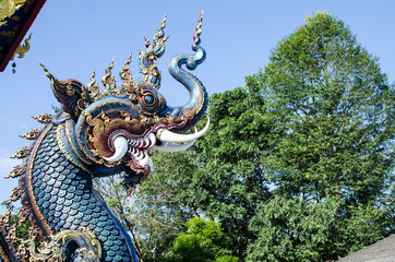 Fototapeta premium Serpent or God of Snake Thai Tradition with Blue Sky at Wat Rong Sua Ten Chiang Rai Thailand. Most Visited from Tourist.