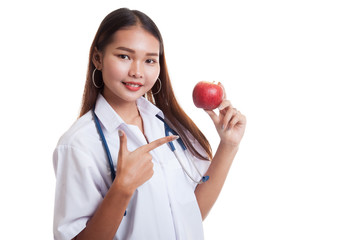 Young Asian female doctor point to an apple.