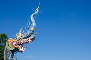Fototapeta na wymiar Serpent or God of Snake Thai Tradition with Blue Sky at Wat Rong Sua Ten Chiang Rai Thailand. Most Visited from Tourist.