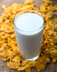 glass of milk and cereals on the wooden table