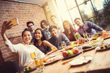 A group of friends are taking selfie friend told others He's com