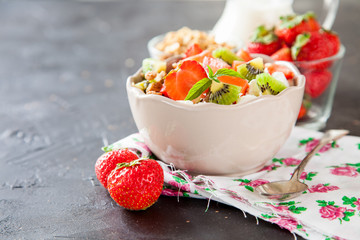muesli with fruit in a bowl on a table, selective focus, copy space
