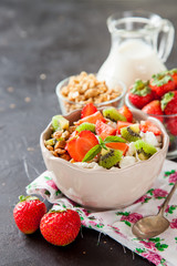 muesli with fruit in a bowl on a table, selective focus, copy space