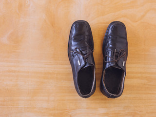 Top view of old shoes on wooden table