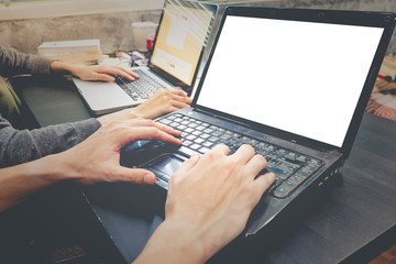 Business partners working together on the same desk, they are using laptop