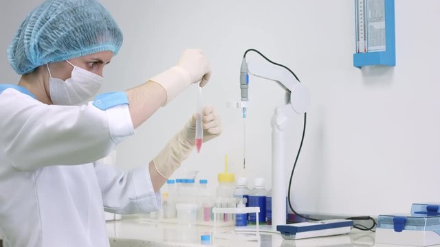 Scientist working in laboratory with biological material, IVF procedure - embryologist prepare sperm in test tube for centrifugation and measure ph.