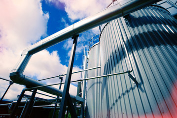 Industrial zone, Steel pipelines and valves against blue sky