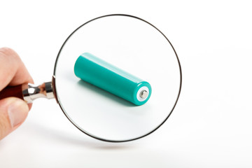 green battery and magnifying glass