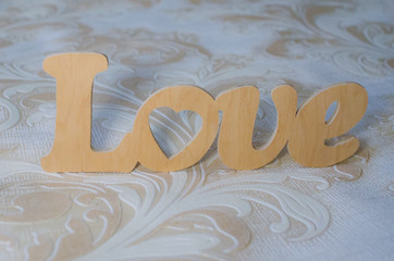 The word love made of wood on a beautiful background