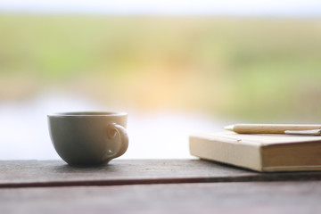 Naklejka na ściany i meble Stock Photo:.A cup of coffee on the wood table
