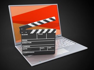 Fototapeta na wymiar 3d illustration of laptop over black background with red screen and film clap