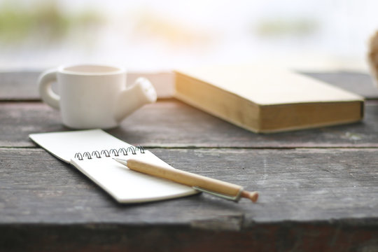 Stock Photo:.Blank notebook with pencil on wooden table