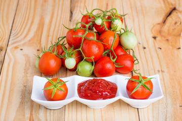 tomato sauce and fresh tomato  on  wooden background