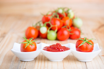 tomato sauce and fresh tomato  on  wooden background