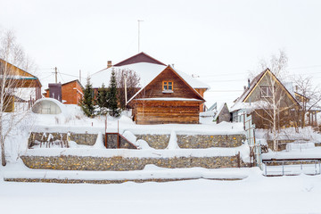 A country cottage built on the banks of the river in the winter.