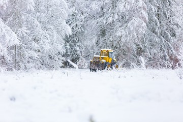 Fototapeta na wymiar Winter landscape with machine (snow plow at work)