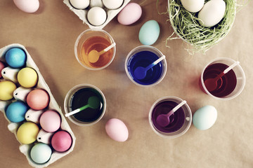 Decorated eggs next to plastic cups