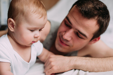 Portrait of loving father with baby boy 4-6 months his son at ho