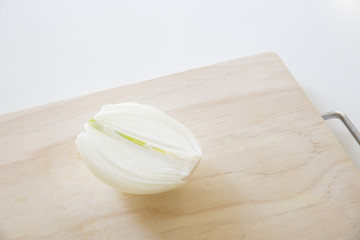 half cut onion on a cutting board