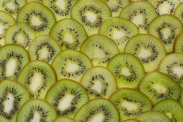 Bright green background with slices of juicy kiwi. Healthy food