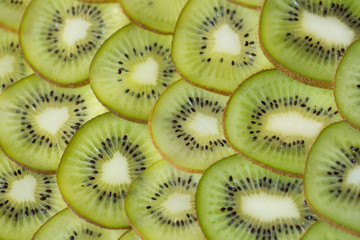 Bright green background with slices of juicy kiwi. Healthy food