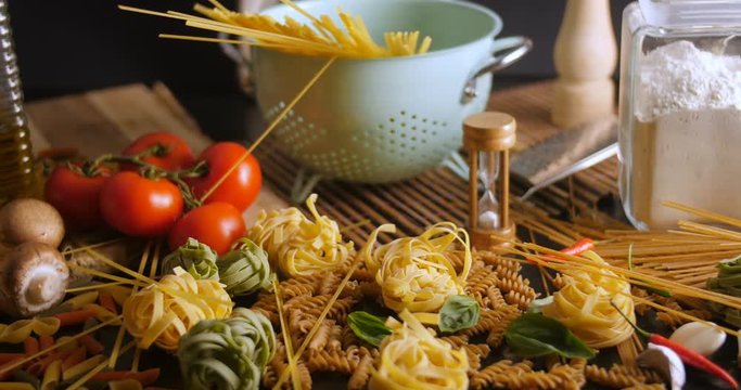 Dolly view of different variety of Italian pasta and ingredients