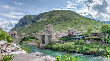Mostar, Bosnia Herzegovina - May 1, 2014: Stari Most bridge and the cross on the hill in Mostar