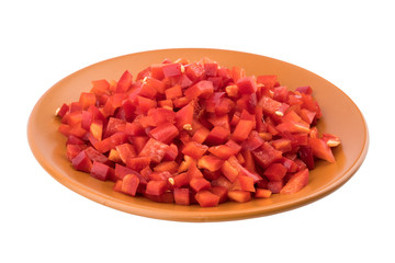 Sliced red pepper in a brown ceramic plate. Isolated on white ba