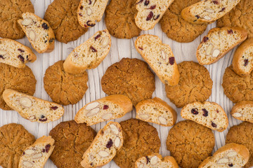 Cookies with almonds and raisins on the old wooden table.