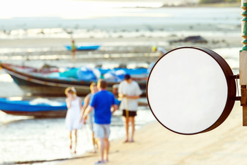 Fototapeta premium Mockup of beach restaurant round sign at asian seashore backgrou