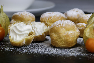 Delicious profiteroles with cream and chocolate glaze