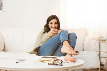 Woman relaxing at home - obrazy, fototapety, plakaty