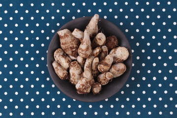 Ready served boiled taro on black dish.